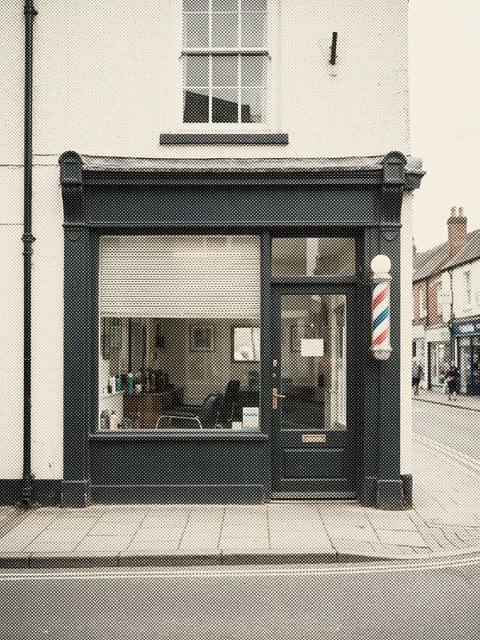 A barber shop front with a striped pole