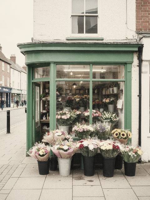 A florist with buckets of flowers outside