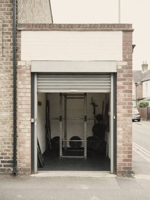 A small gym behind a roller shutter